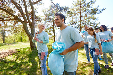 Image showing volunteers with garbage bags walking outdoors