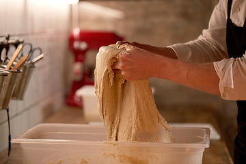 Image showing chef or baker cooking dough at bakery