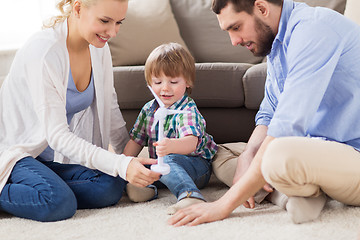 Image showing happy family playing with toy wind turbine