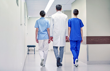 Image showing group of medics or doctors walking along hospital