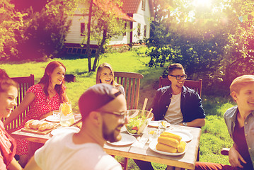 Image showing happy friends having dinner at summer garden party