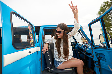 Image showing happy hippie woman showing peace in minivan car