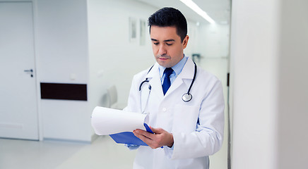 Image showing doctor writing to clipboard at hospital