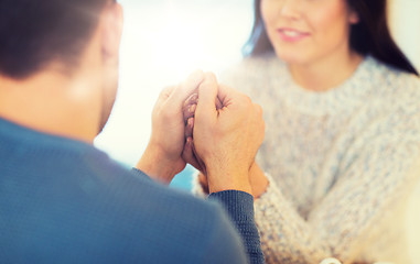 Image showing happy couple holding hands at restaurant or cafe