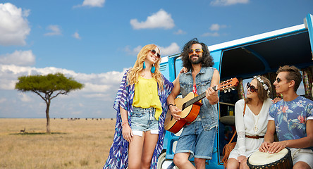 Image showing hippie friends playing music at minivan in africa