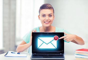 Image showing smiling student girl with laptop at school