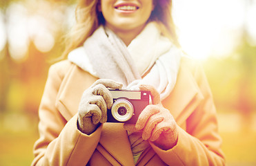 Image showing close up of woman with camera in autumn park