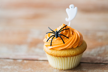 Image showing cupcake with halloween decoration on table