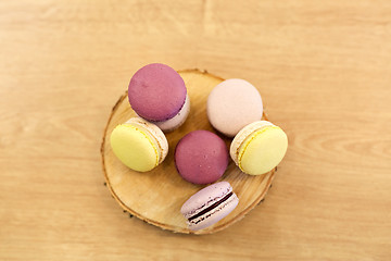 Image showing different macarons on wooden stand