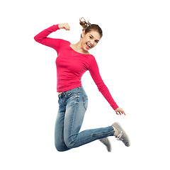 Image showing smiling young woman jumping in air