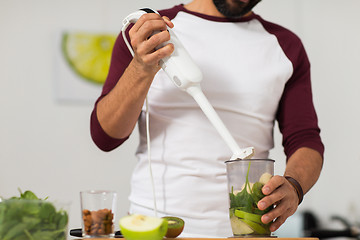 Image showing man with blender and fruit cooking at home kitchen