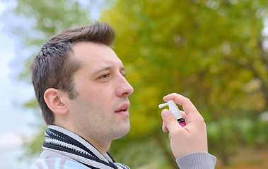 Image showing Man spraying with nasal spray