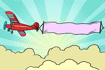 Image showing Retro airplane with a ribbon in the sky