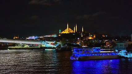 Image showing Night shot of Golden Horn Metro Bridge or Halic Bridge overlapping Suleymaniye Mosque, Istanbul, Turkey