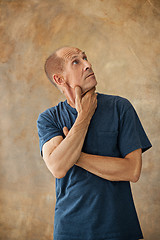 Image showing Worried mature man touching his head.