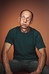 Image showing Worried mature man sitting at studio