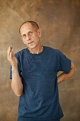 Image showing Worried mature man standing at studio