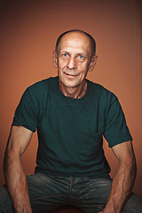 Image showing Worried mature man sitting at studio