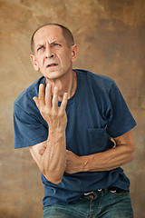 Image showing Worried mature man standing at studio