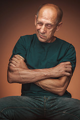 Image showing Worried mature man sitting at studio