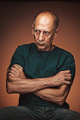 Image showing Worried mature man sitting at studio