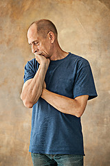 Image showing Worried mature man touching his head.