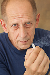 Image showing Worried mature man sitting at studio