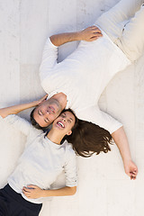 Image showing handsome couple lying on floor