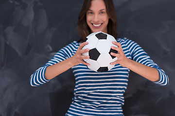 Image showing woman holding a soccer ball in front of chalk drawing board