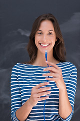 Image showing woman holding a internet cable in front of chalk drawing board