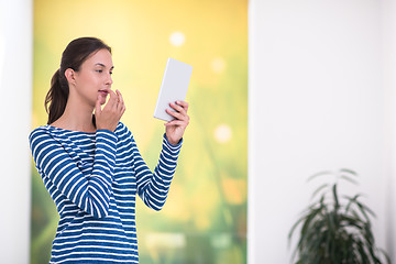 Image showing young woman at home websurfing