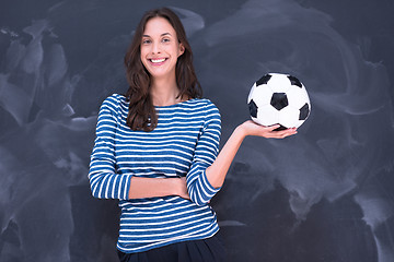 Image showing woman holding a soccer ball in front of chalk drawing board