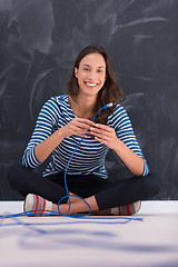 Image showing woman holding a internet cable in front of chalk drawing board