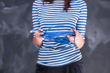 Image showing woman holding a internet cable in front of chalk drawing board