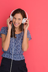 Image showing woman with headphones isolated on a red