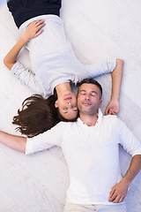 Image showing handsome couple lying on floor