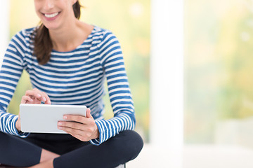 Image showing young women using tablet computer on the floor