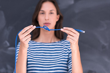 Image showing woman holding a internet cable in front of chalk drawing board