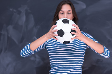 Image showing woman holding a soccer ball in front of chalk drawing board