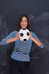 Image showing woman holding a soccer ball in front of chalk drawing board