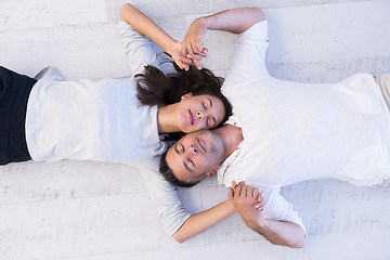 Image showing handsome couple lying on floor