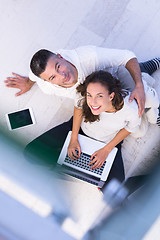 Image showing couple using tablet and laptop computers top view