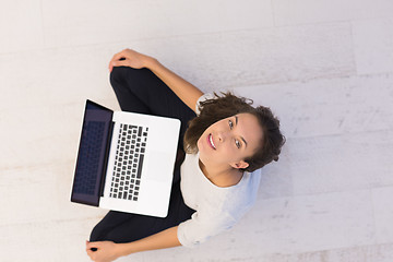 Image showing women using laptop computer on the floor top view