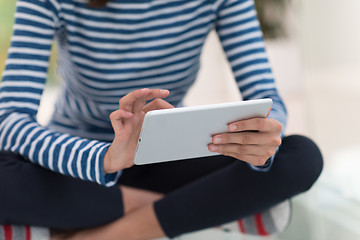 Image showing young women using tablet computer on the floor