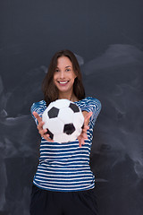 Image showing woman holding a soccer ball in front of chalk drawing board