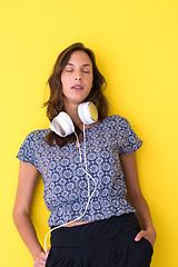 Image showing woman with headphones isolated on a yellow