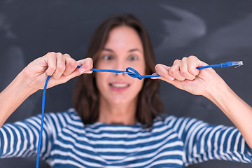 Image showing woman holding a internet cable in front of chalk drawing board