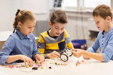 Image showing happy children building robots at robotics school