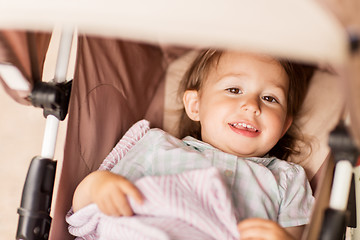 Image showing little child or baby lying in stroller outdoors