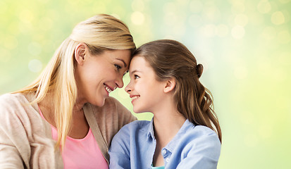 Image showing happy girl with mother hugging over lights